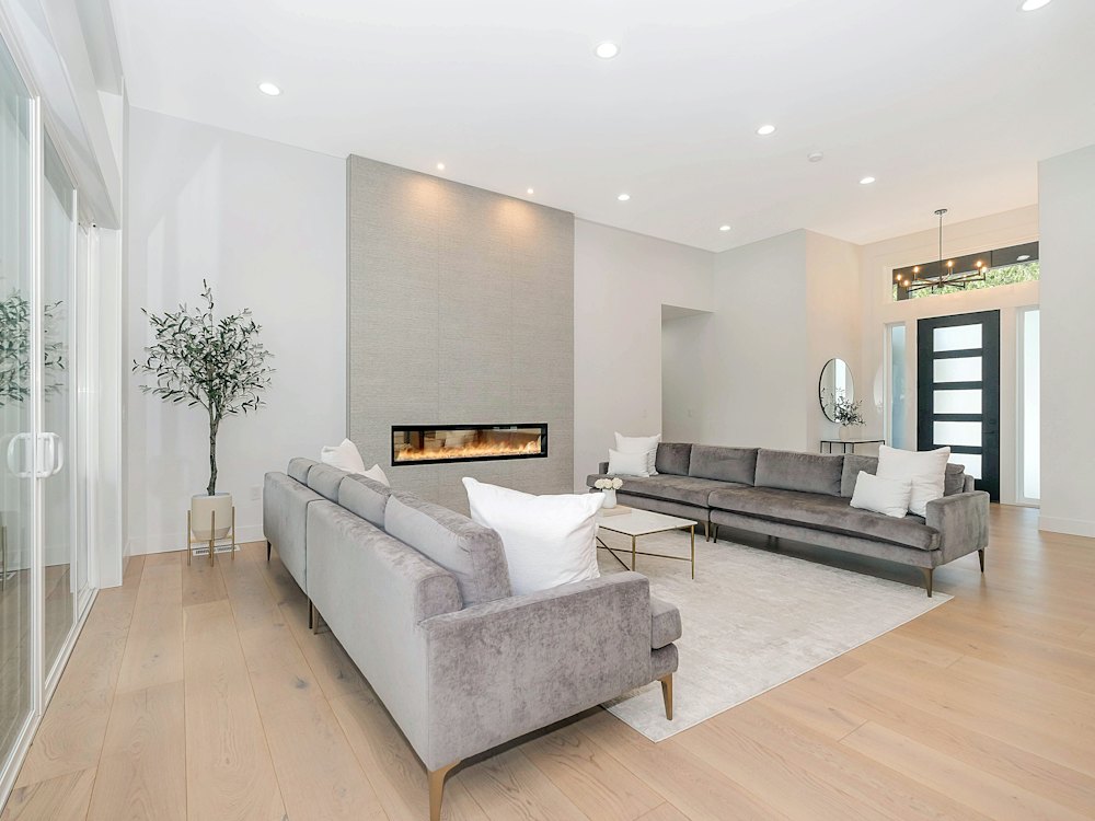 Modern living room with light, cool toned wood plank floors