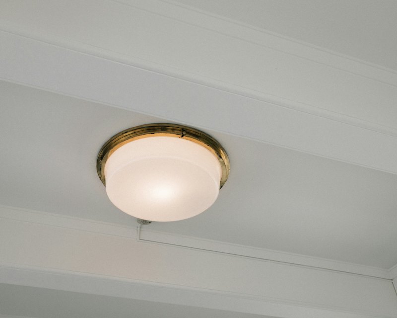White semi flush ceiling light with brass trim